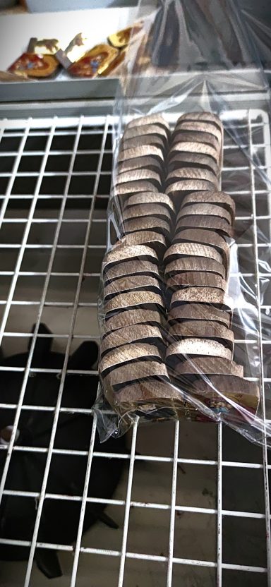 Drying Stage in the Workshop Wooden icon pieces drying on metal rack after finishing process